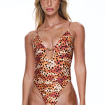 Woman wearing a leopard print swimsuit on a white background