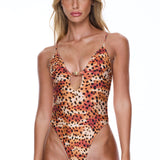 Woman wearing a leopard print swimsuit on a white background