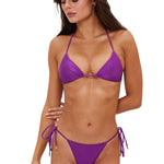 Woman wearing a purple bikini on a white background