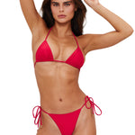 Woman wearing a red bikini on a white background