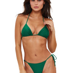 Woman wearing a green bikini against a white background