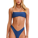 Woman wearing a blue bikini set on a white background