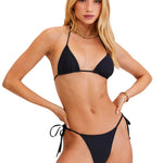 Woman wearing a black bikini on a white background