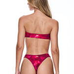 Woman wearing a pink bikini on a white background