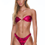 Woman wearing a red bikini against a white background