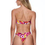 Woman wearing a colorful floral bikini on a white background