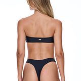 Woman wearing a black bikini on a white background