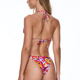 Woman wearing a colorful bikini on a white background