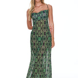 Woman wearing a green patterned dress on a white background