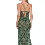 Woman wearing a green patterned dress on a white background